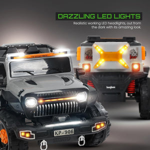 Grey and black battery operated kids jeep ride-on car with orange accents, features working headlights, overhead lights, and underbody glow, on rocky terrain." www.usmile.toys