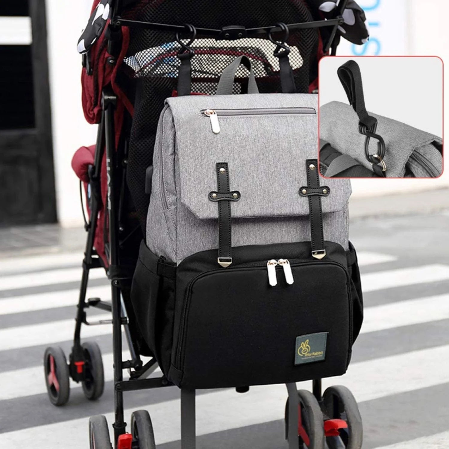 Stylish R For Rabbit Caramello Smart Baby Diaper Bag in grey and black, designed as a spacious backpack with multiple compartments and a front zipper pocket, perfect for organizing baby essentials. From uSmile.toys." www.usmile.toys