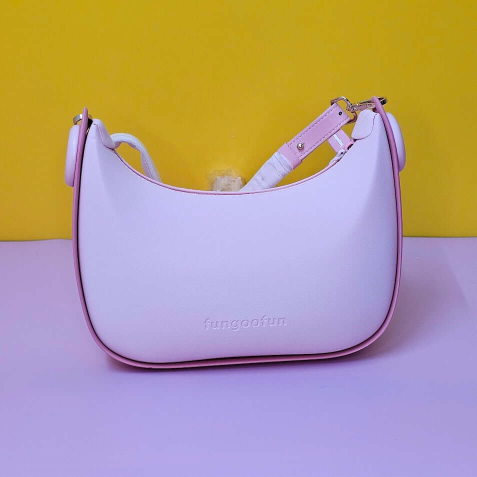 Pink handbag with a yellow background