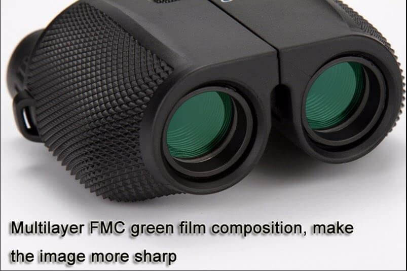 Black binoculars with green lenses on a white background