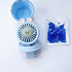 "Usmile Toys portable mini desk fan set for children, designed with an adorable bunny ear top and a compact base, perfect for study or play areas, available in blue and pink." www.usmile.toys