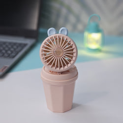 Front view of two Usmile Toys Hi Speed Kids Desk Fans, a blue and a pink one, showing their round grilles with a 'hello' emoji and charming bunny ears, suitable for adding a breeze and fun to any desk."
