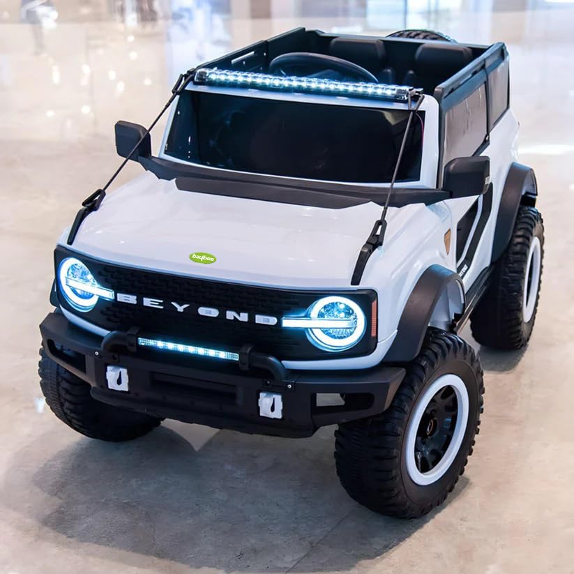 White battery operated kids jeep ride-on toy car with black accents, featuring bright LED headlights, roof lights, and music, suitable for children's play." www.usmile.toys