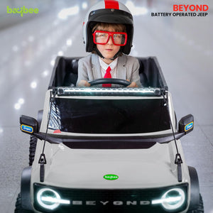 White battery operated kids jeep ride-on toy car with black accents, featuring bright LED headlights, roof lights, and music, suitable for children's play." www.usmile.toys