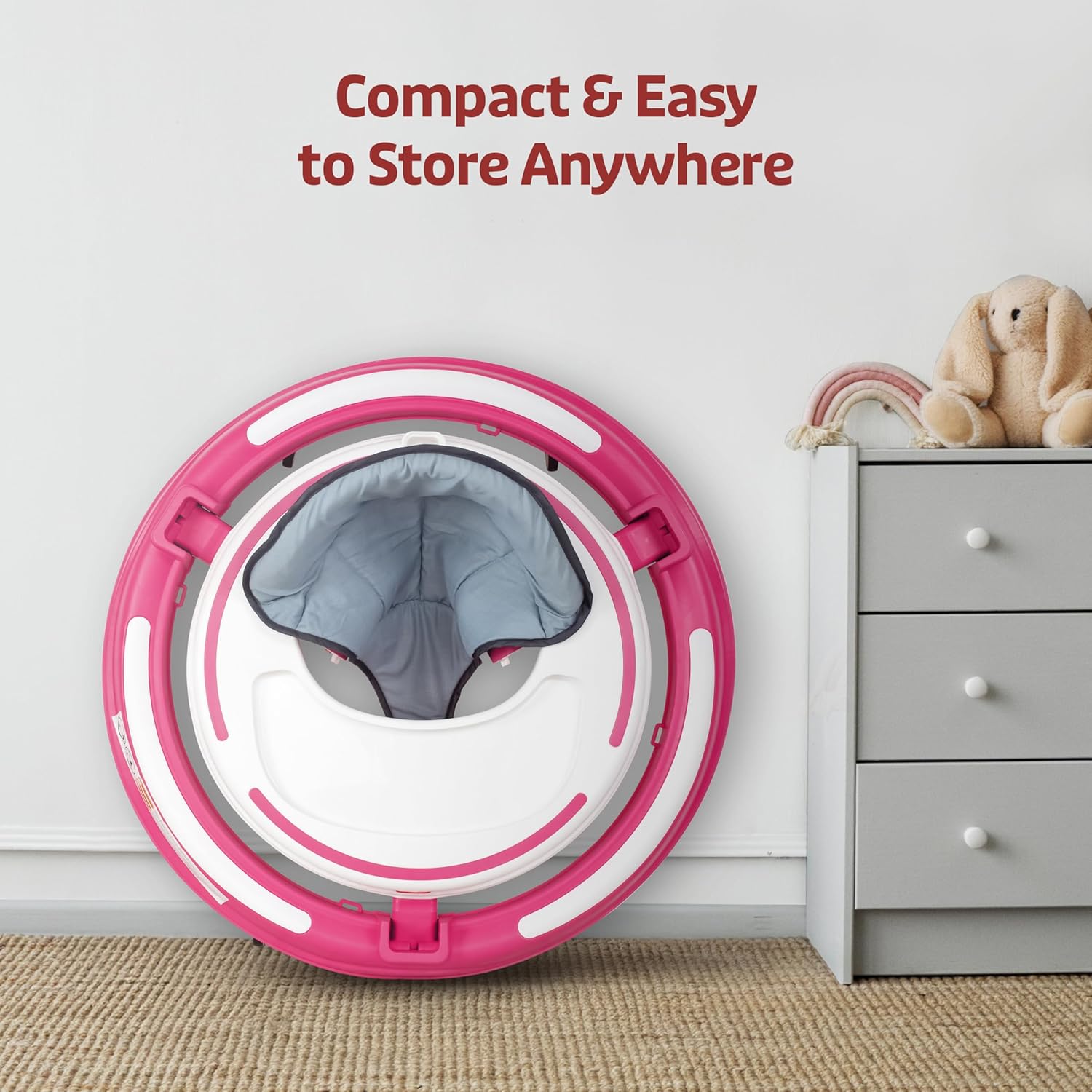 LuvLap 360° Joy baby walker in pink and white, featuring a comfortable gray padded seat, multi-level height adjustment, and engaging toys on the activity tray for infants 9+ months.  www.usmile.toys