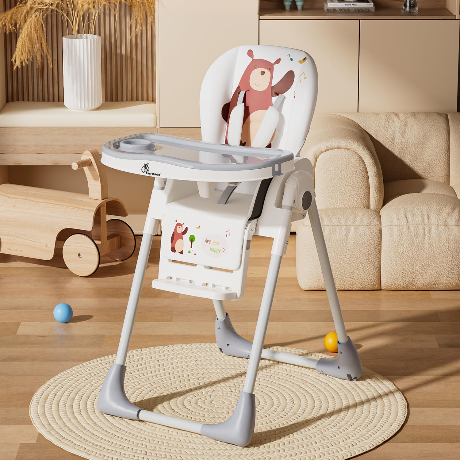 White and grey Marshmallow Lite baby high chair with 6 adjustable height levels, comfortable and secure for infant feeding, featuring a playful bear motif. www.usmile.toys