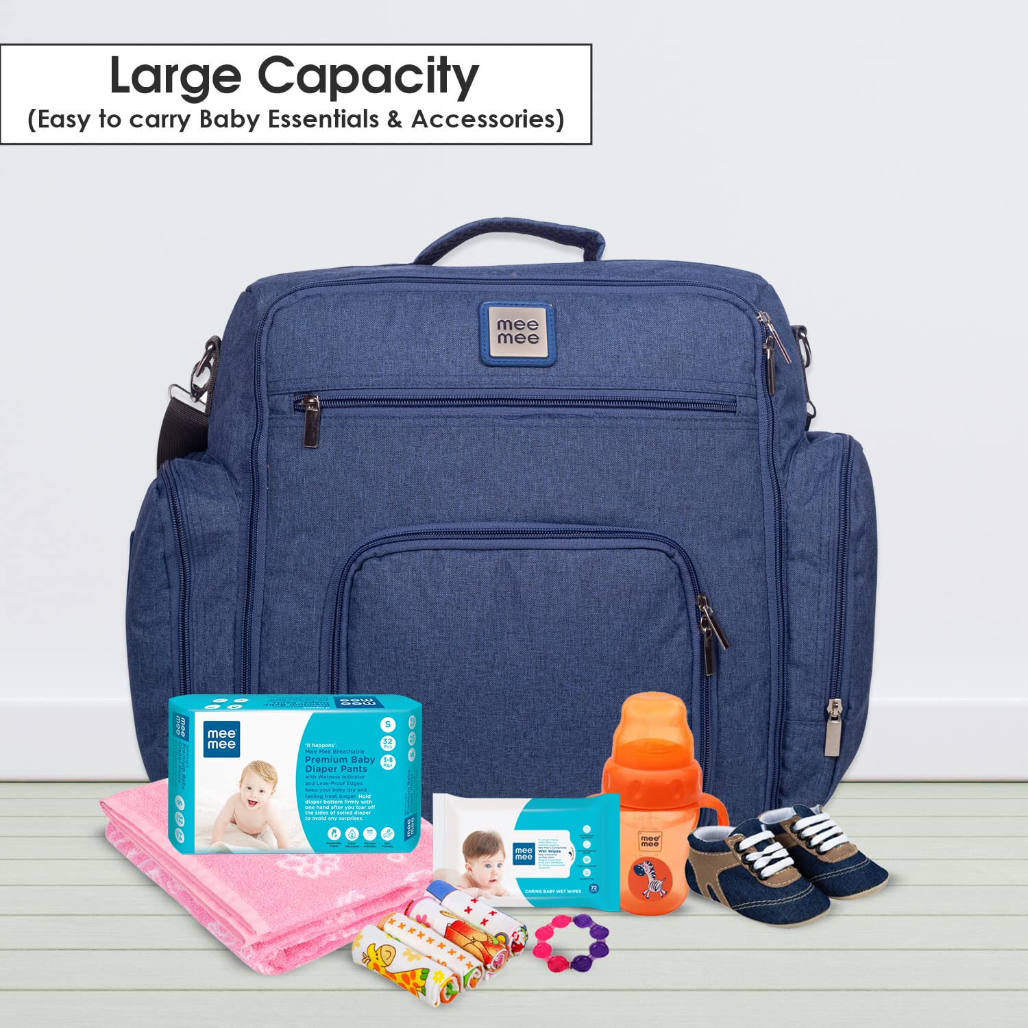 Spacious blue Mee Mee diaper bag with multiple zippered pockets, padded handles, and an adjustable shoulder strap for parents. www.usmile.toys