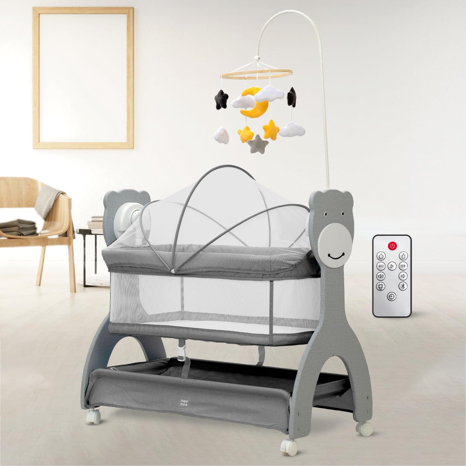Grey Mee Mee infant cradle with mesh sides, overhead mobile with stars and moon, and a convenient remote control for soothing. www.usmile.toys