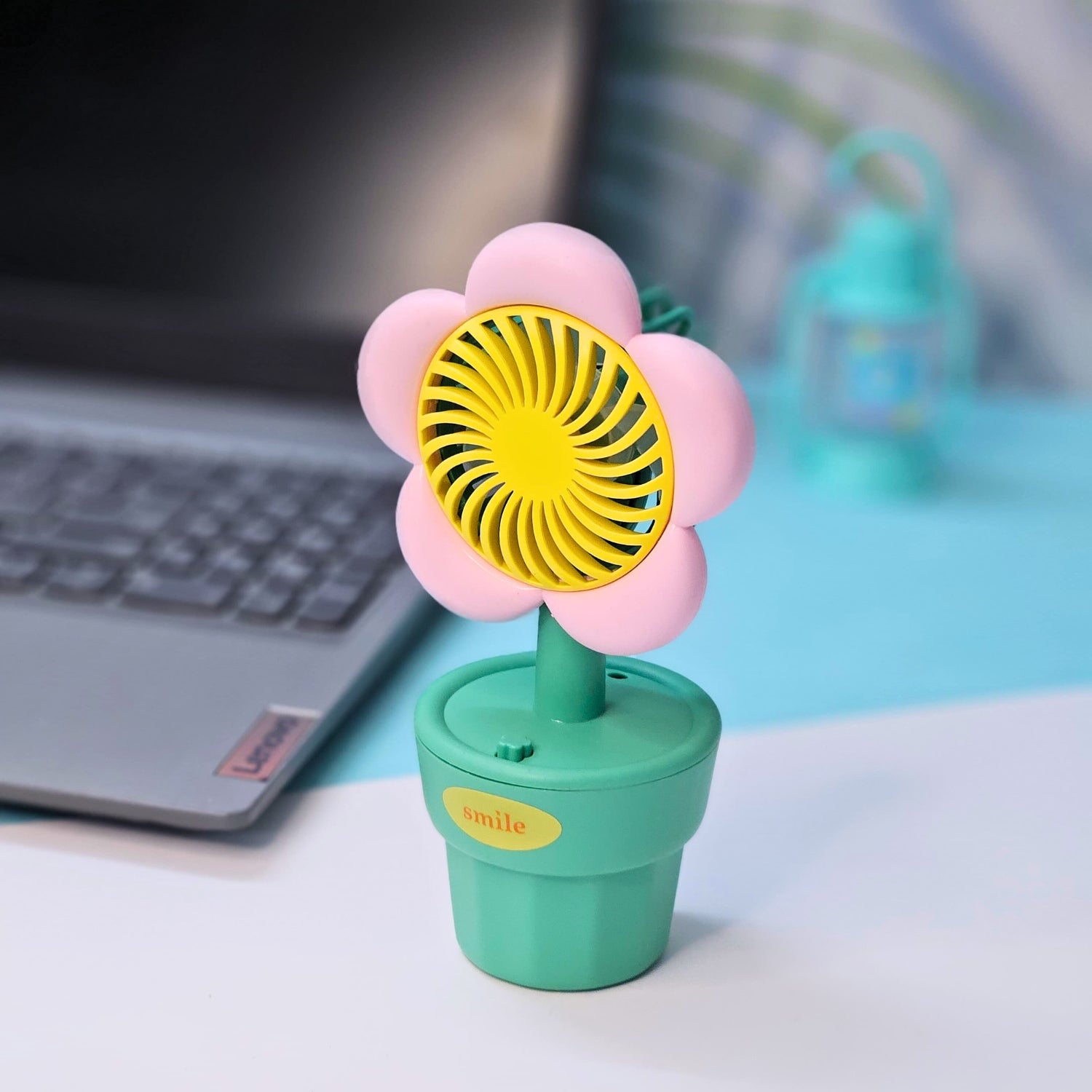 Set of three Usmile Toys flower-shaped mini desk fans in yellow, purple, and pink, each in a green pot with 'smile' text, perfect for kids' rooms or desks." www.usmile.toys