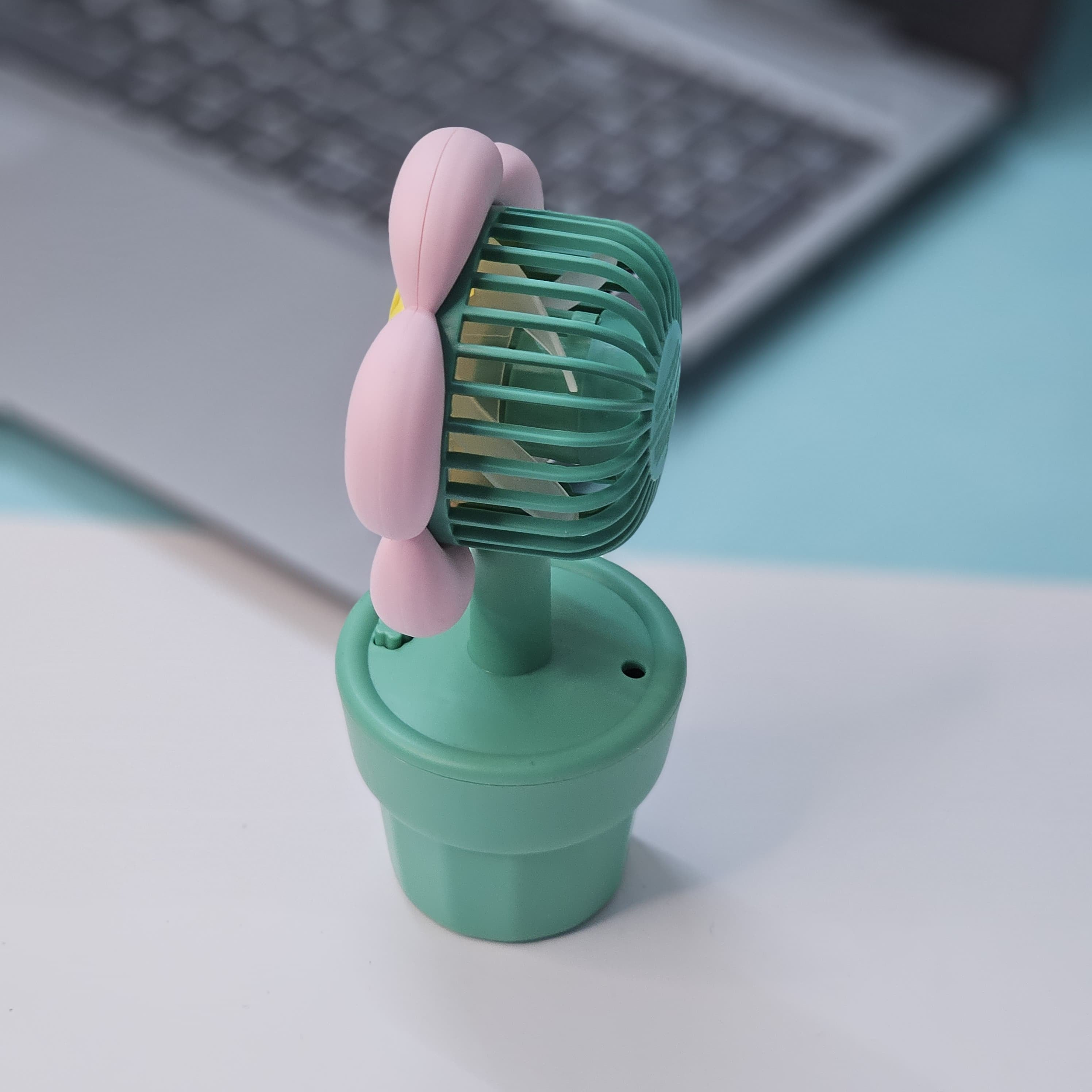 Set of three Usmile Toys flower-shaped mini desk fans in yellow, purple, and pink, each in a green pot with 'smile' text, perfect for kids' rooms or desks.