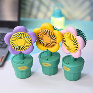Usmile Toys 'Mini Desk Fan for Kids': an adorable flower-designed fan in yellow, purple, and pink, providing a gentle breeze as a cute desktop accessory."www.usmile.toys