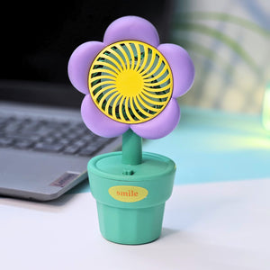 Usmile Toys 'Mini Desk Fan for Kids': an adorable flower-designed fan in yellow, purple, and pink, providing a gentle breeze as a cute desktop accessory."www.usmile.toys