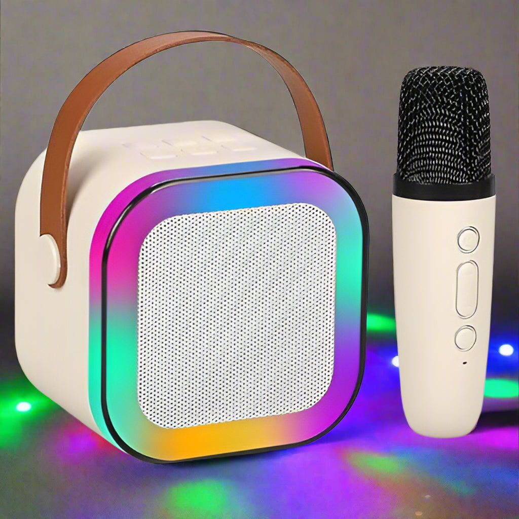 Kids' mini karaoke system with a white square LED Bluetooth speaker and a small matching handheld microphone for singing. www.usmile.toys