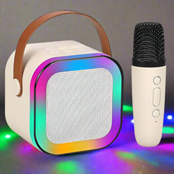 Kids' mini karaoke system with a white square LED Bluetooth speaker and a small matching handheld microphone for singing. www.usmile.toys