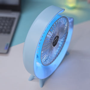 Light blue Usmile Toys moon-shaped high-speed desk fan, featuring a captivating blue LED glow, designed for efficient personal cooling on desktops." www.usmile,toys
