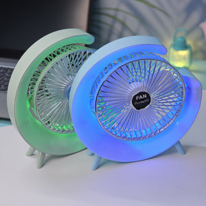 Light blue Usmile Toys moon-shaped high-speed desk fan, featuring a captivating blue LED glow, designed for efficient personal cooling on desktops." www.usmile,toys