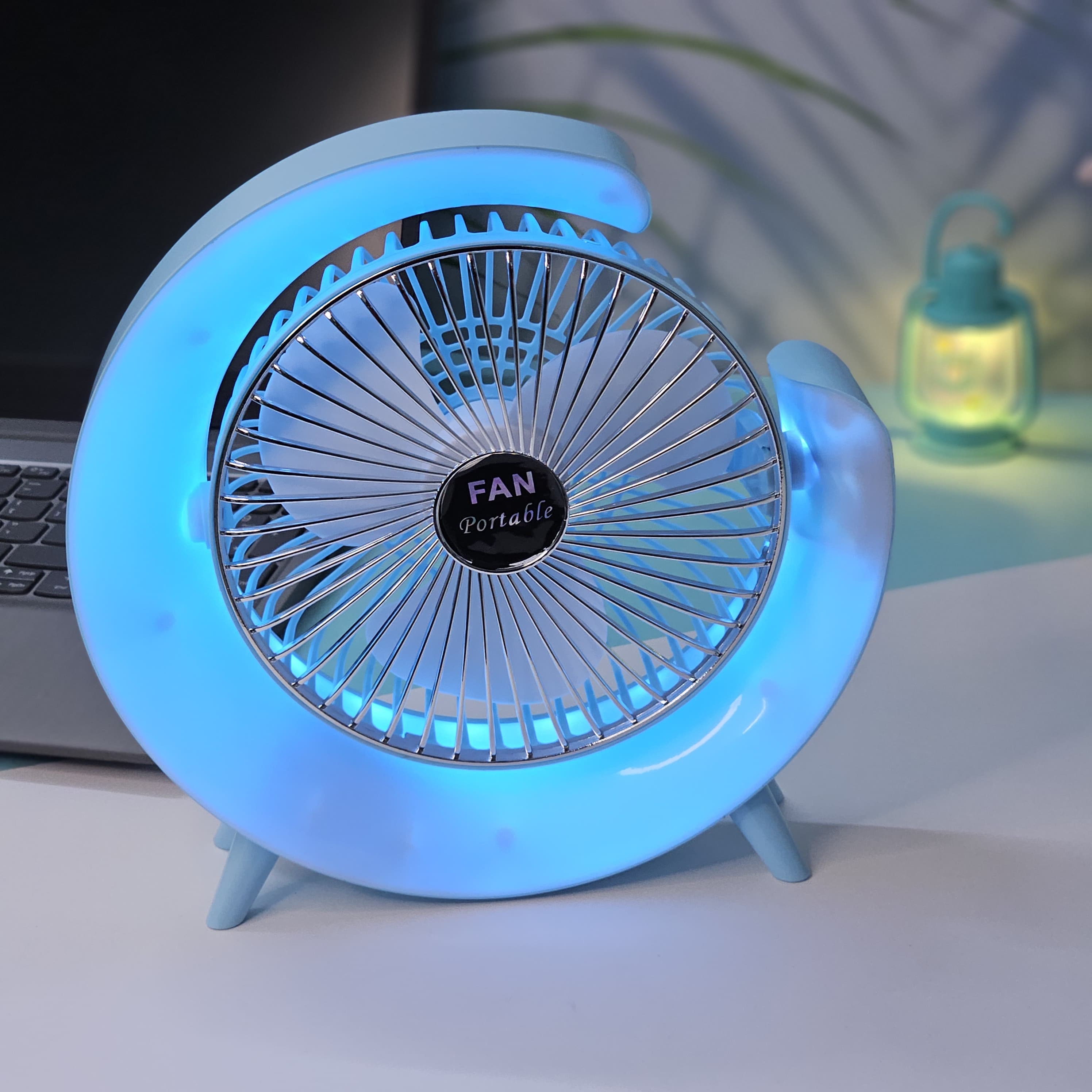 "Usmile Toys modern mini fan: a sleek, crescent moon-shaped desk fan with built-in LED lighting, providing powerful airflow for home or office."