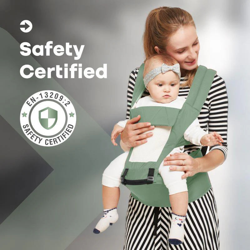 Happy mother carrying her baby in a green R For Rabbit Upsy Daisy 4-in-1 Baby Carrier with ergonomic design, suitable for multiple carrying positions. Shows a baby facing outwards, securely strapped. From uSmile.toys.