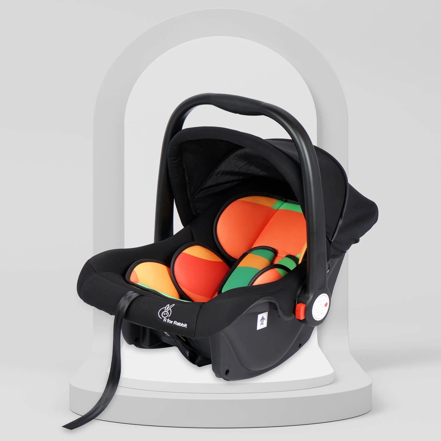 Black R For Rabbit Picabo 4-in-1 Baby Carrycot and Car Seat with vibrant orange and green padded interior, a sturdy handle, and a protective canopy. Designed for safe infant travel and comfort. From uSmile.toys." www.usmile.toys