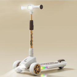 "The R for Rabbit Road Runner Blaze, a premium foldable 3-wheel kick scooter for children, presented in a sleek dark grey with stylish gold wheel accents. This scooter boasts durable PU LED light-up wheels, 4  adjustable height levels to grow with your child, and integrated light & music features for an enhanced riding experience. Available at Usmile Toys." www.usmile toys