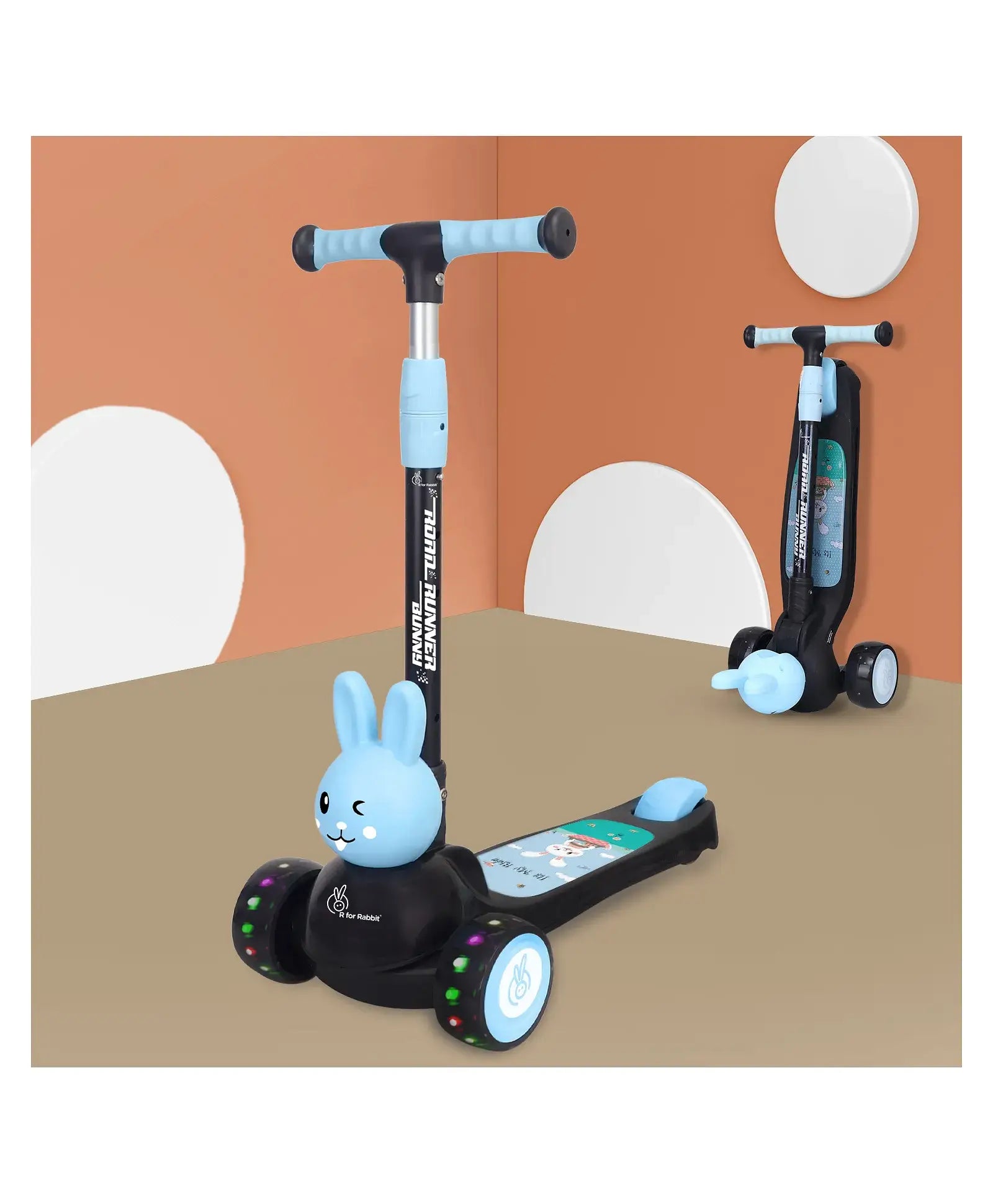 Children's scooter with a blue bunny design on a beige surface and orange wall background