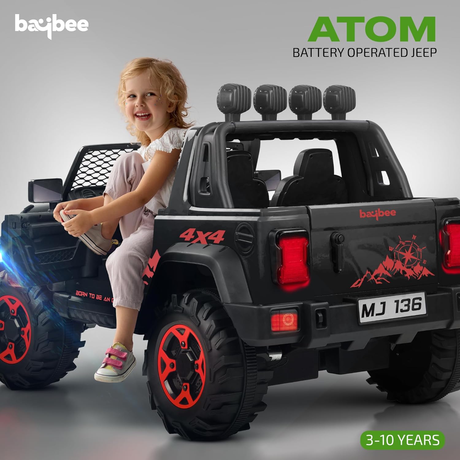 Black battery operated kids jeep ride-on car with red accents, features Bluetooth, music, and working lights, driving through mud. www.usmile.toys