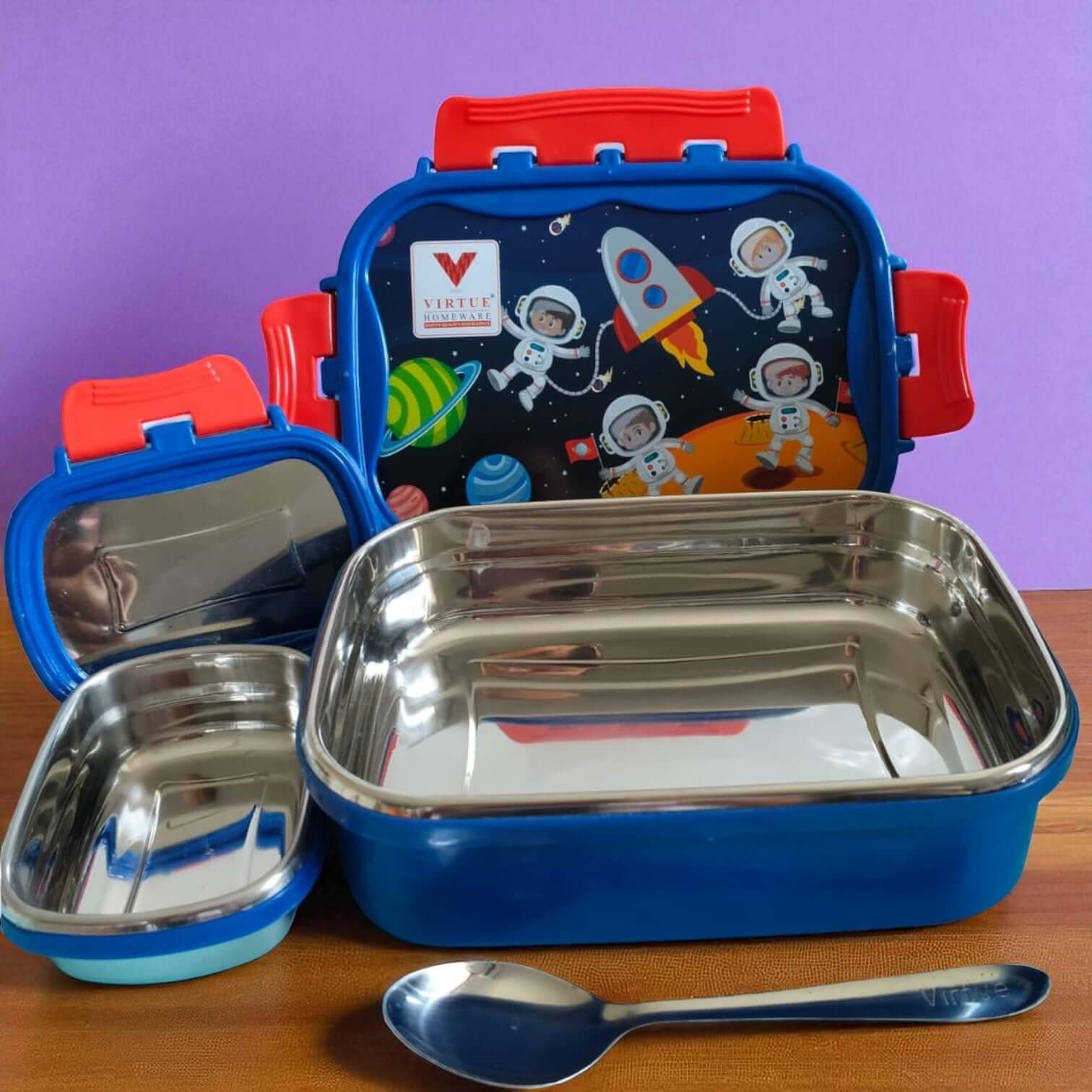 Children's lunchbox set with blue container, red handles, and space-themed design on a purple background.