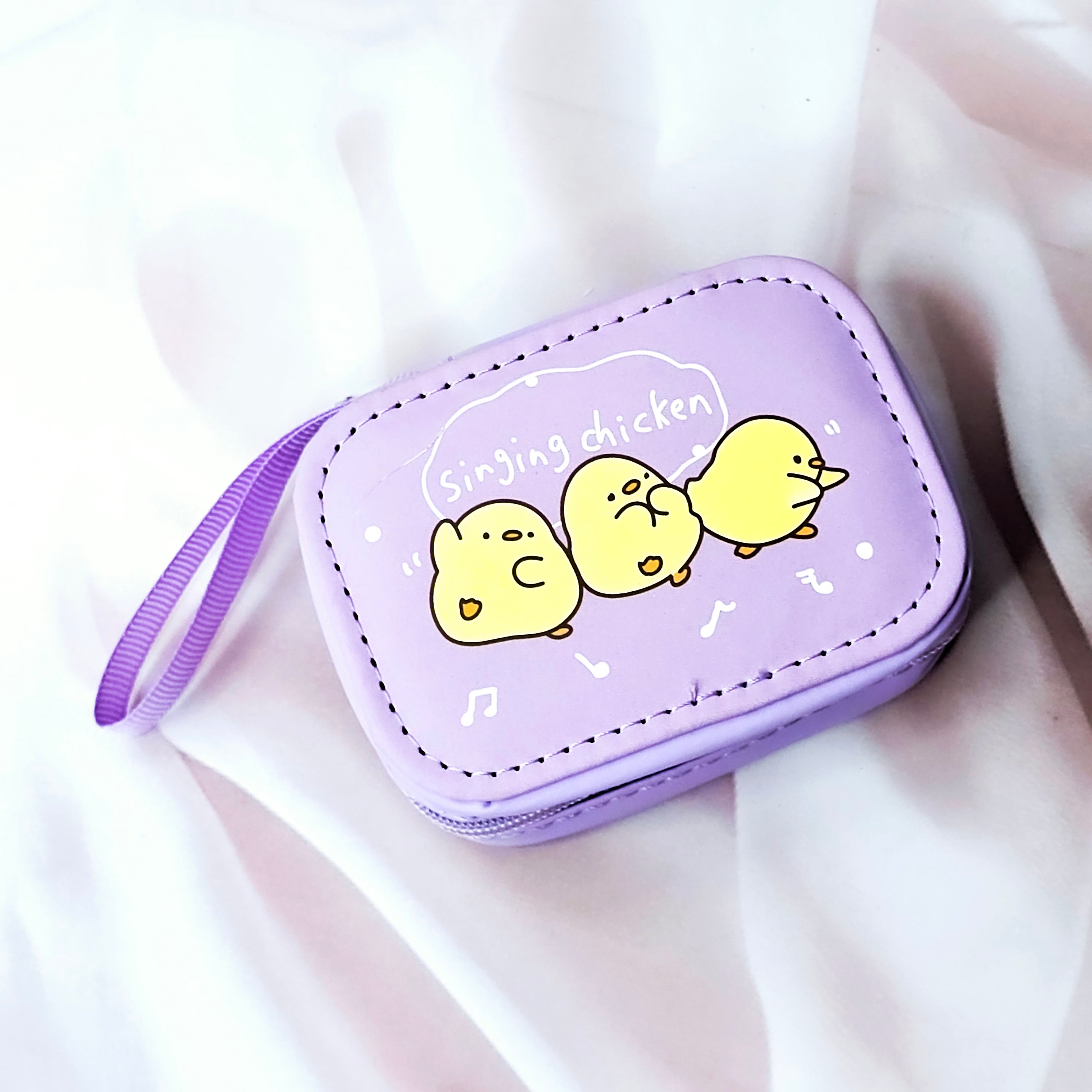 Assorted cute cartoon small storage coin pouches for kids in pink and purple with animal characters. www.smile.toys