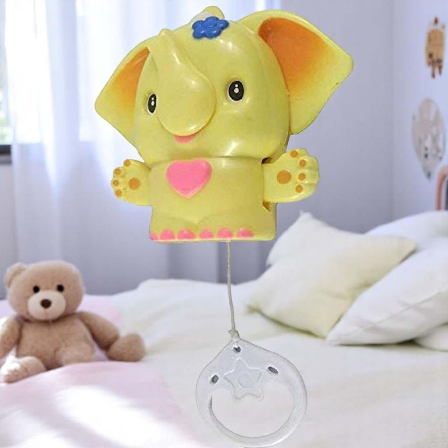 Yellow elephant-shaped musical cradle bell toy with a red heart, packaged for babies. This hanging toy produces sweet sounds, perfect for entertaining infants in cribs, strollers, or playpens, promoting auditory development. www.usmile.com