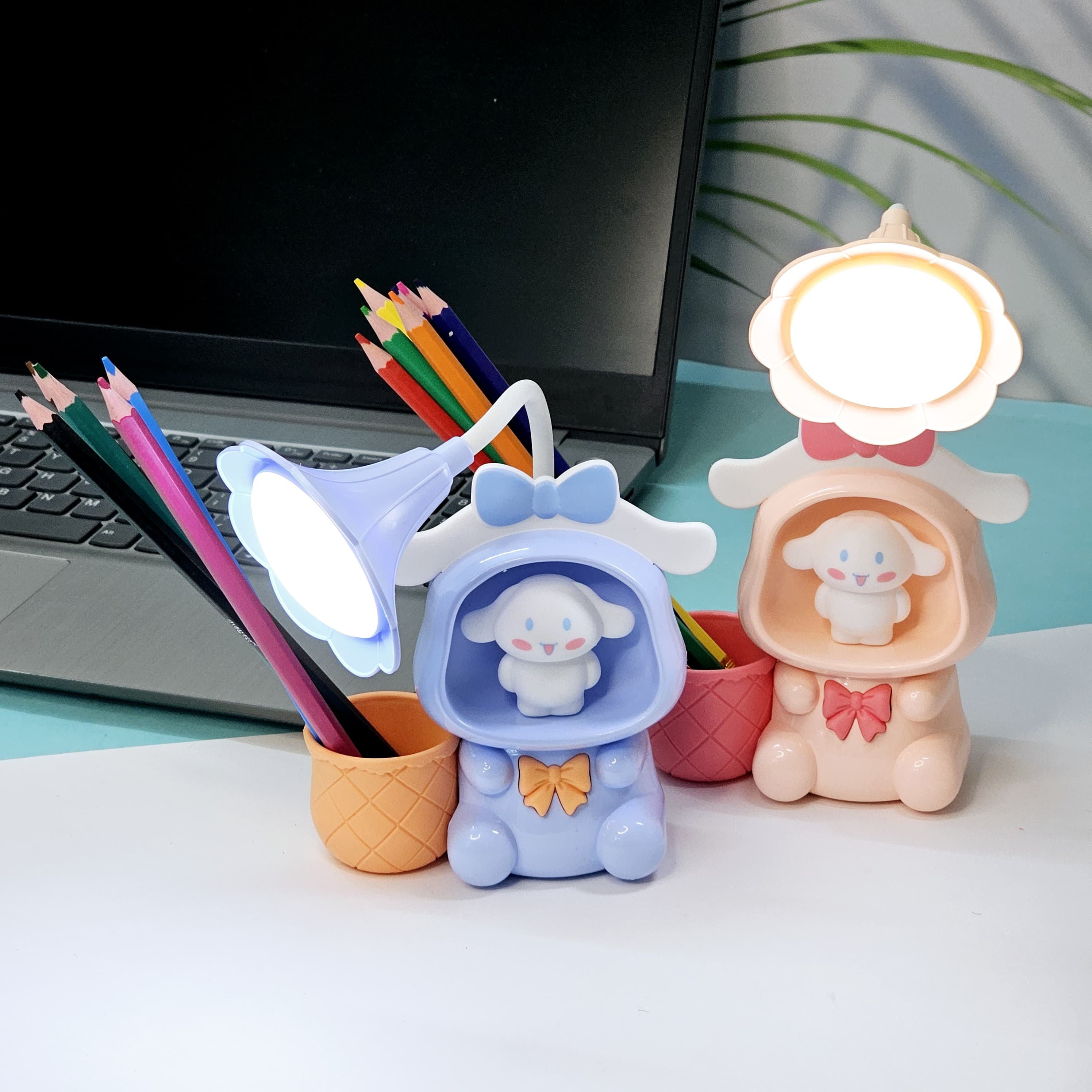 Set of three Usmile Toys Astronaut Teddy Lamps in blue, pink, and green, each featuring a glowing flower-shaped light and a base designed as a convenient pencil holder." www.usmile.toys