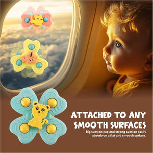 Child looking out of an airplane window with butterfly-shaped fidget toys attached to the window.