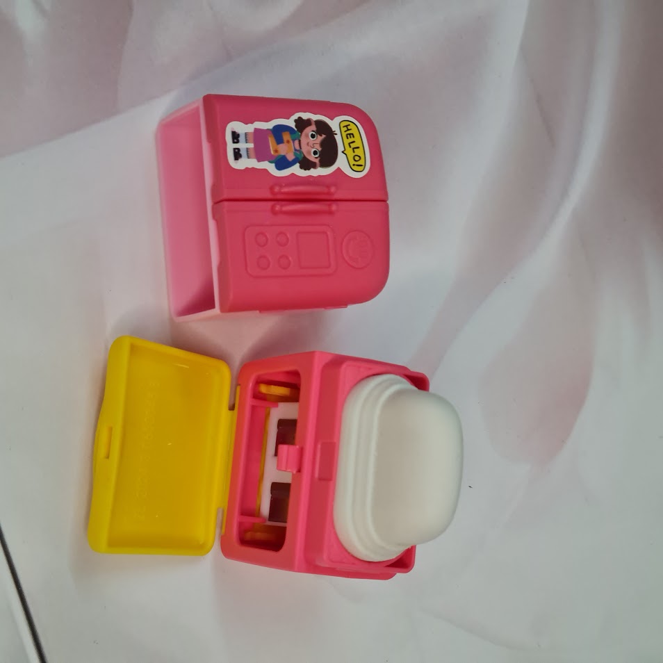 Set of four Usmile Toys adorable fridge-shaped sharpeners and erasers in pink, green, blue, and purple, each with cartoon character decals." www.usmile.toys
