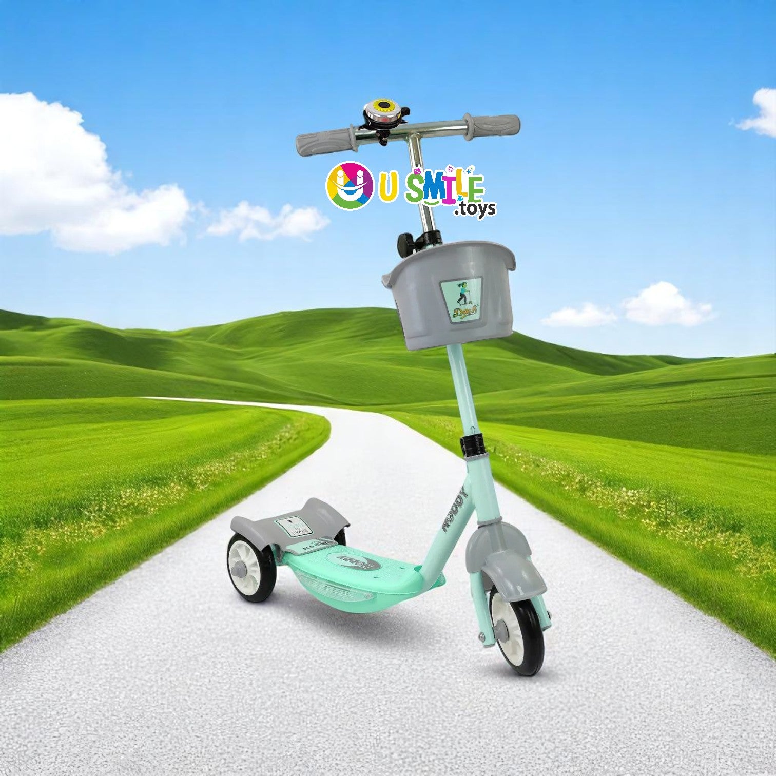 Dash New Noddy Scooter in green and grey for kids aged 3+ years, featuring a front basket and bell, on a scenic path www.usmile.toys