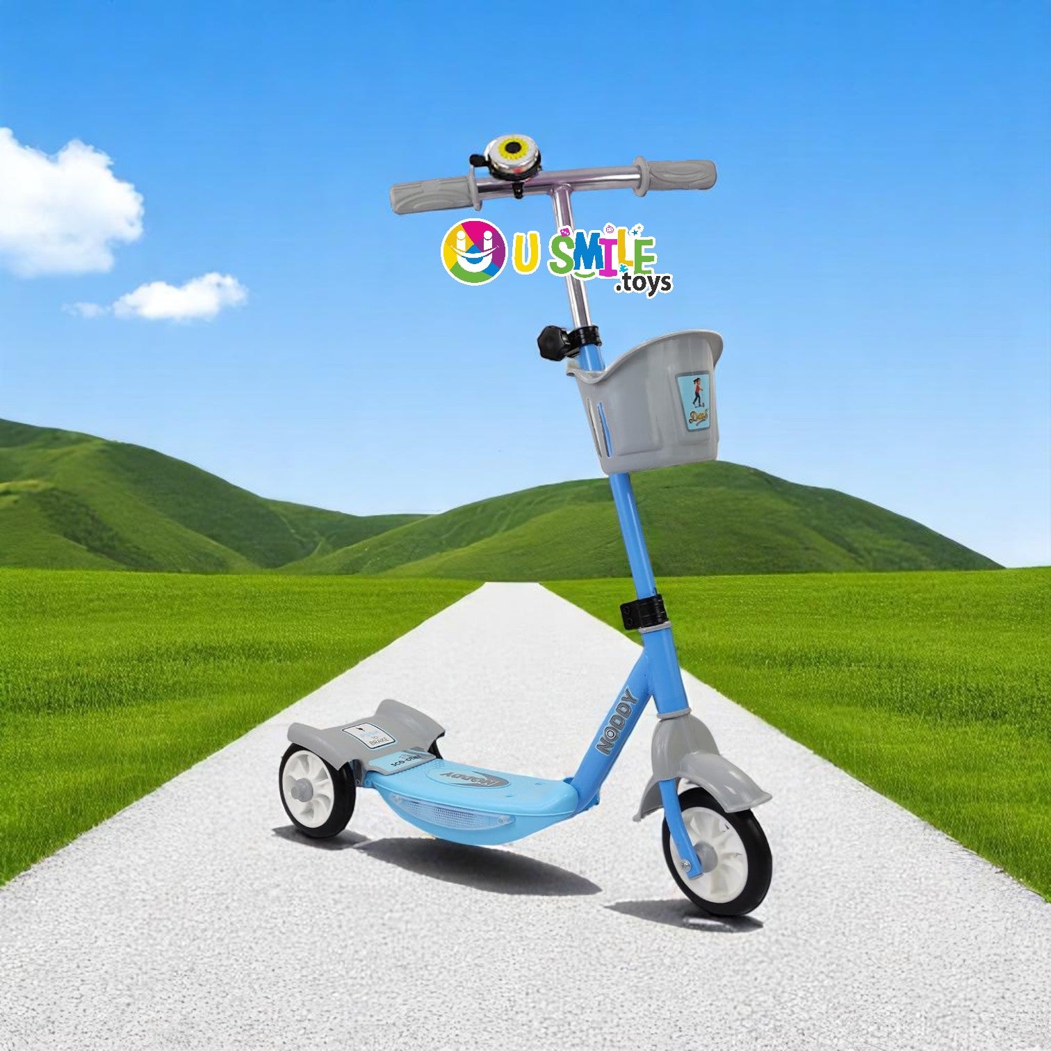Dash New Noddy Scooter in green and grey for kids aged 3+ years, featuring a front basket and bell, on a scenic path www.usmile.toys