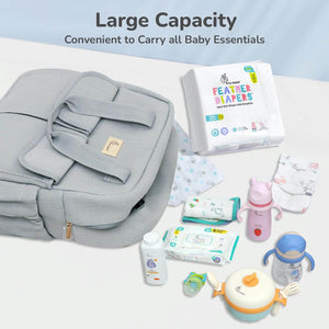Gray backpack with baby essentials including diapers, wipes, and bottles on a light blue background.
