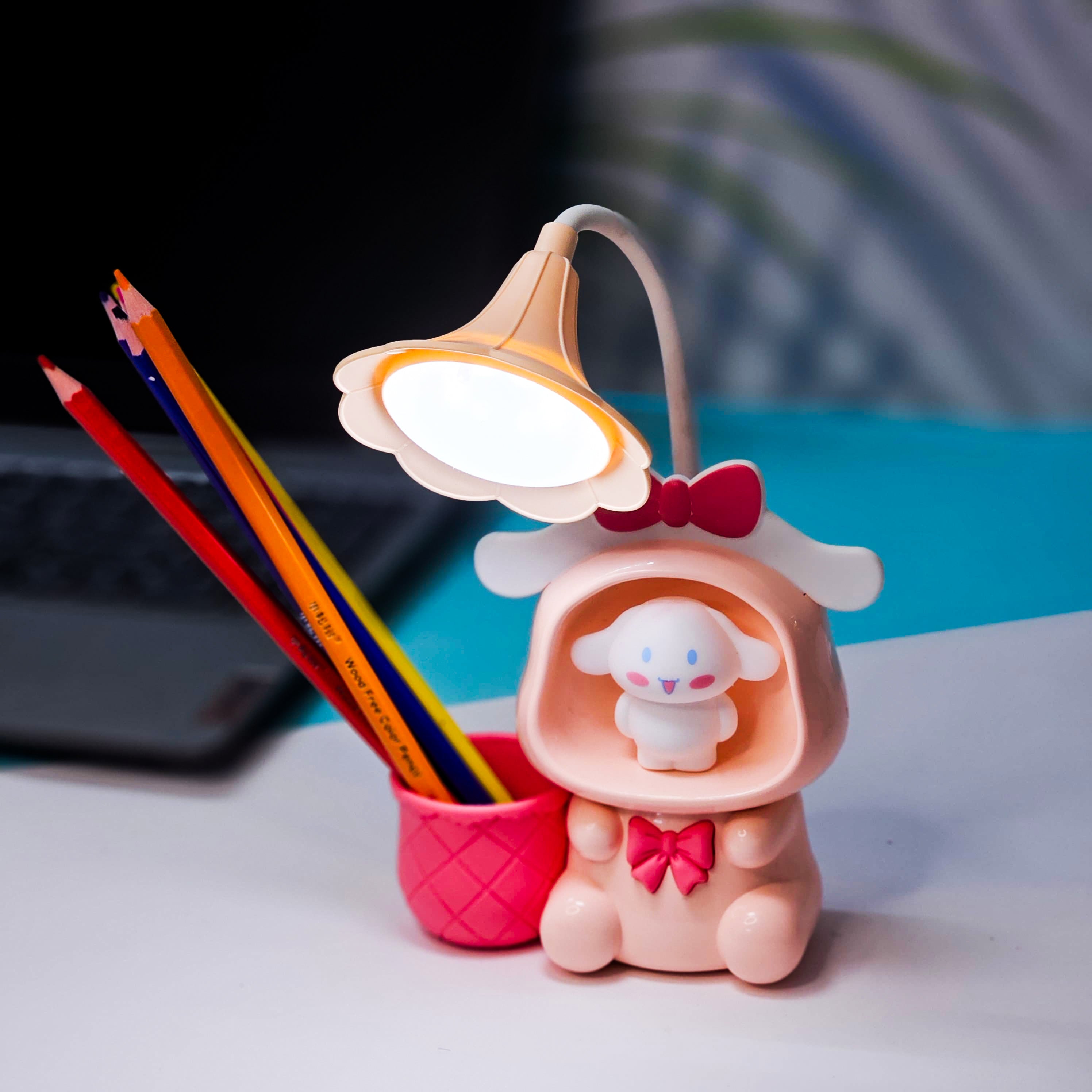 Set of three Usmile Toys Astronaut Teddy Lamps in blue, pink, and green, each featuring a glowing flower-shaped light and a base designed as a convenient pencil holder." www. usmile.toys