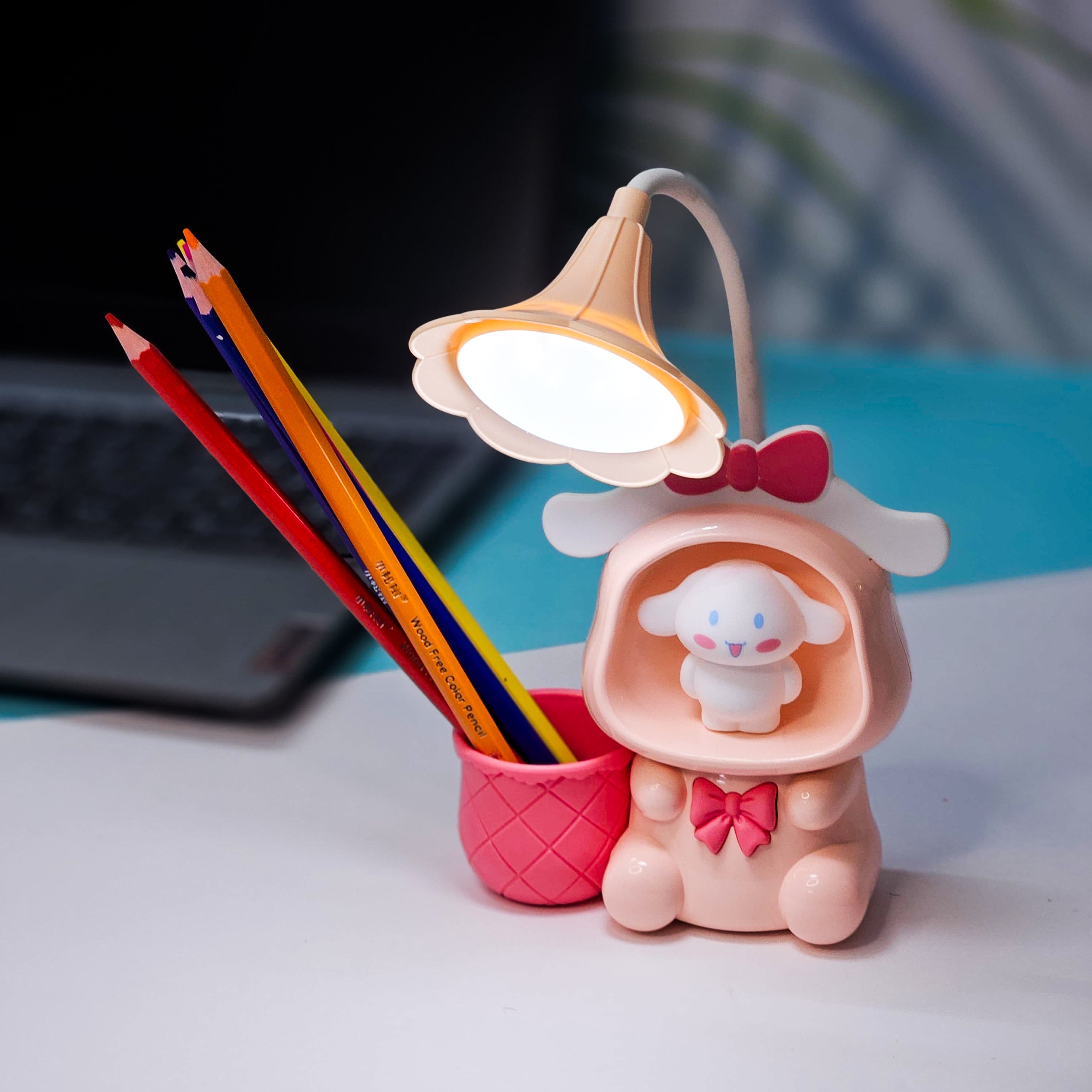 Set of three Usmile Toys Astronaut Teddy Lamps in blue, pink, and green, each featuring a glowing flower-shaped light and a base designed as a convenient pencil holder." www.usmile.toys