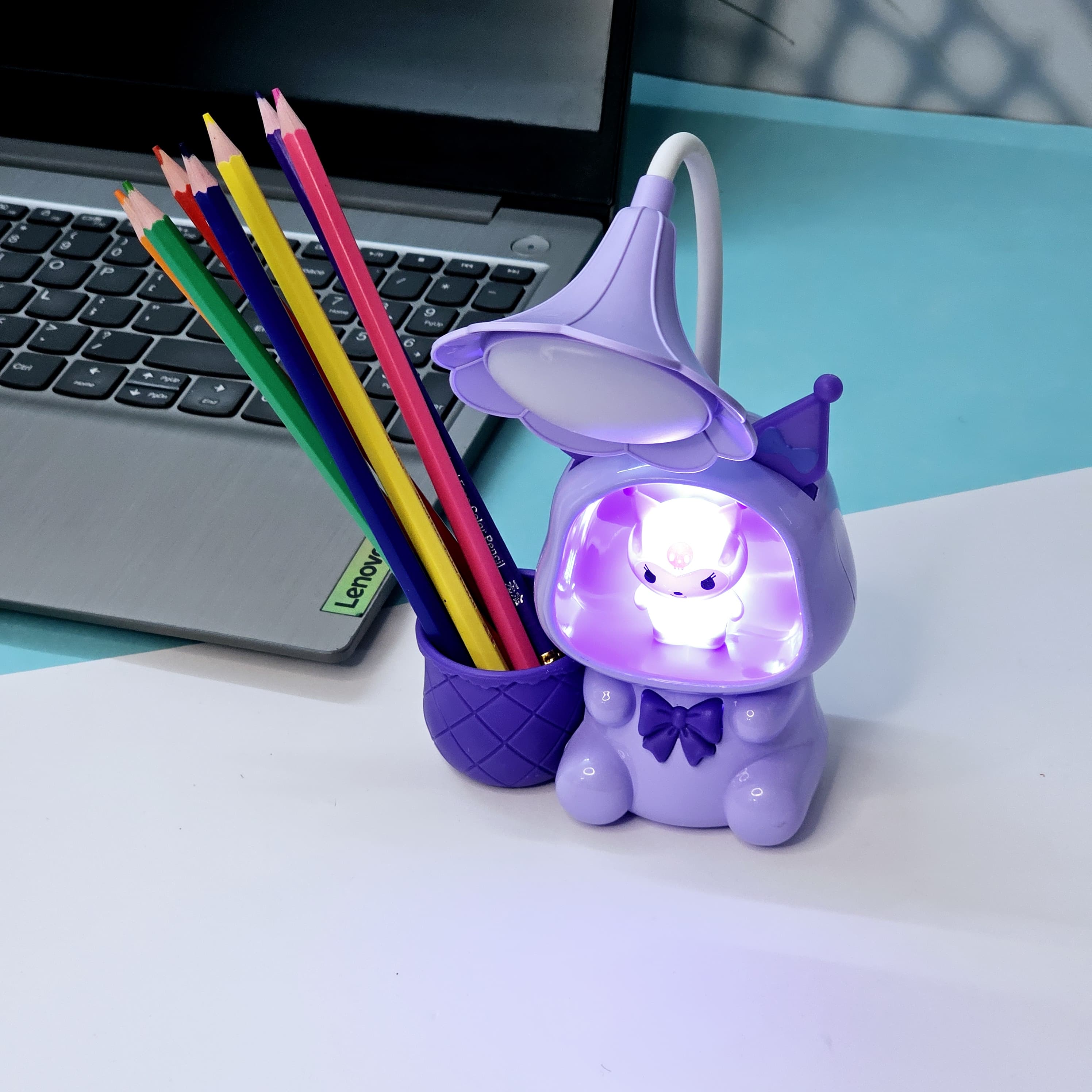 Set of three Usmile Toys Astronaut Teddy Lamps in blue, pink, and green, each featuring a glowing flower-shaped light and a base designed as a convenient pencil holder." www.usmile.toys