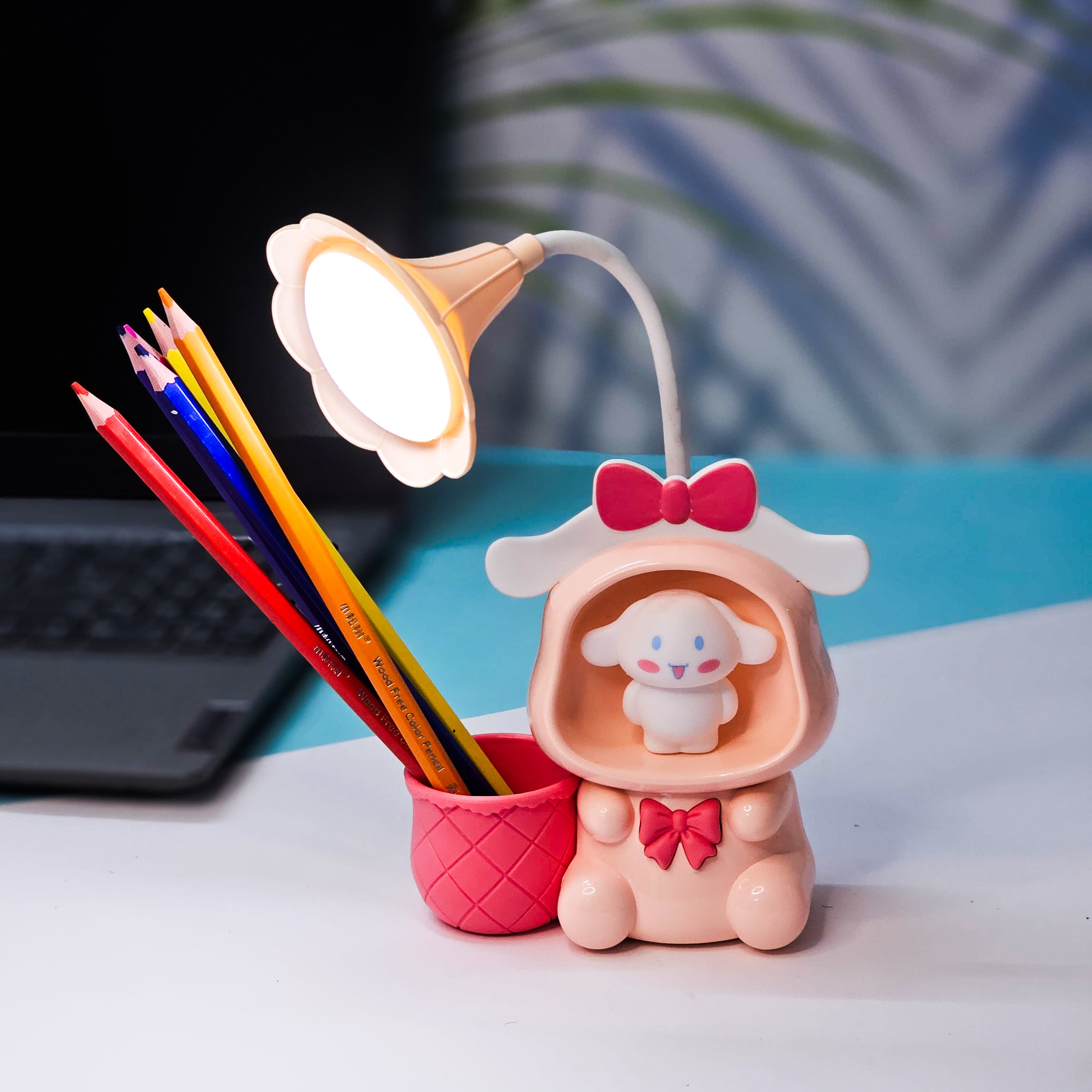 Set of three Usmile Toys Astronaut Teddy Lamps in blue, pink, and green, each featuring a glowing flower-shaped light and a base designed as a convenient pencil holder." www.usmile.toys