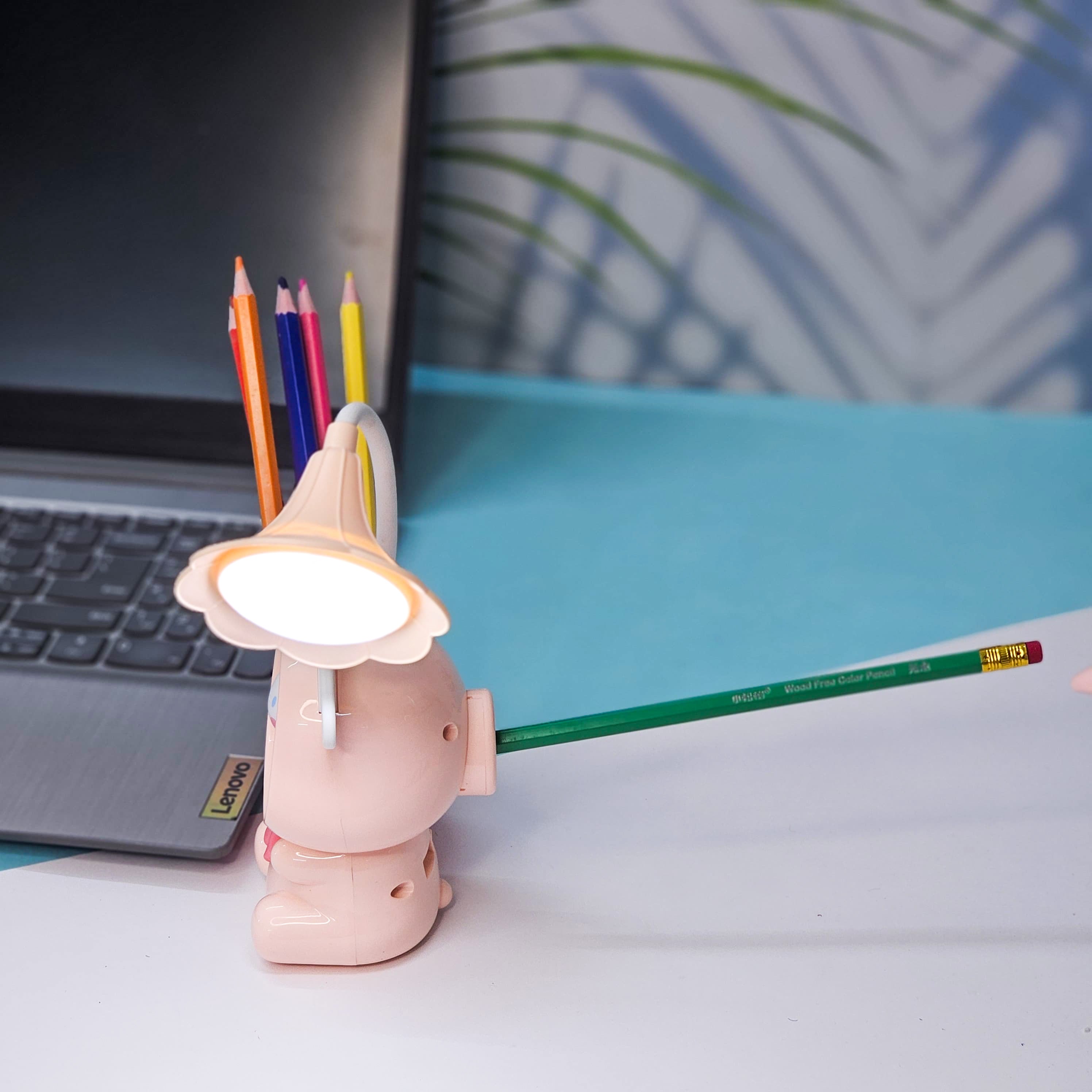 Set of three Usmile Toys Astronaut Teddy Lamps in blue, pink, and green, each featuring a glowing flower-shaped light and a base designed as a convenient pencil holder.