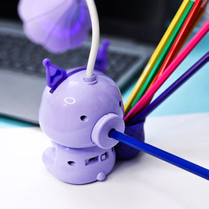 Set of three Usmile Toys Astronaut Teddy Lamps in blue, pink, and green, each featuring a glowing flower-shaped light and a base designed as a convenient pencil holder."