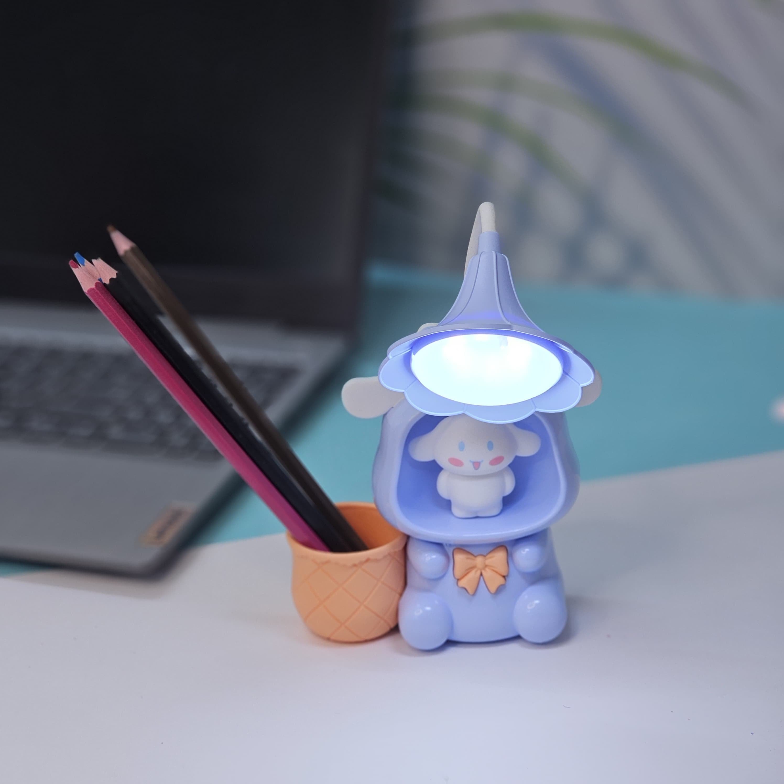 Set of three Usmile Toys Astronaut Teddy Lamps in blue, pink, and green, each featuring a glowing flower-shaped light and a base designed as a convenient pencil holder."