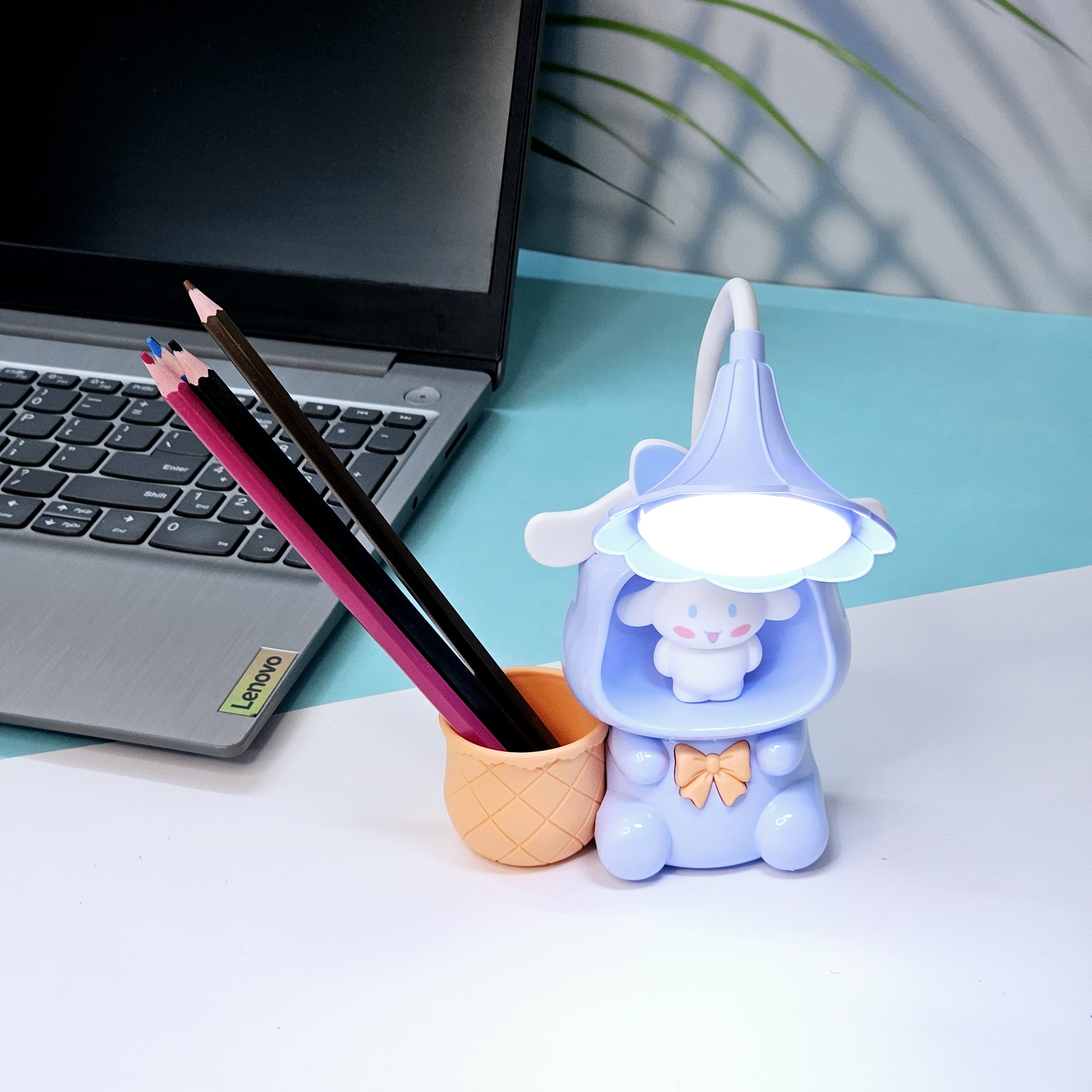 Set of three Usmile Toys Astronaut Teddy Lamps in blue, pink, and green, each featuring a glowing flower-shaped light and a base designed as a convenient pencil holder.