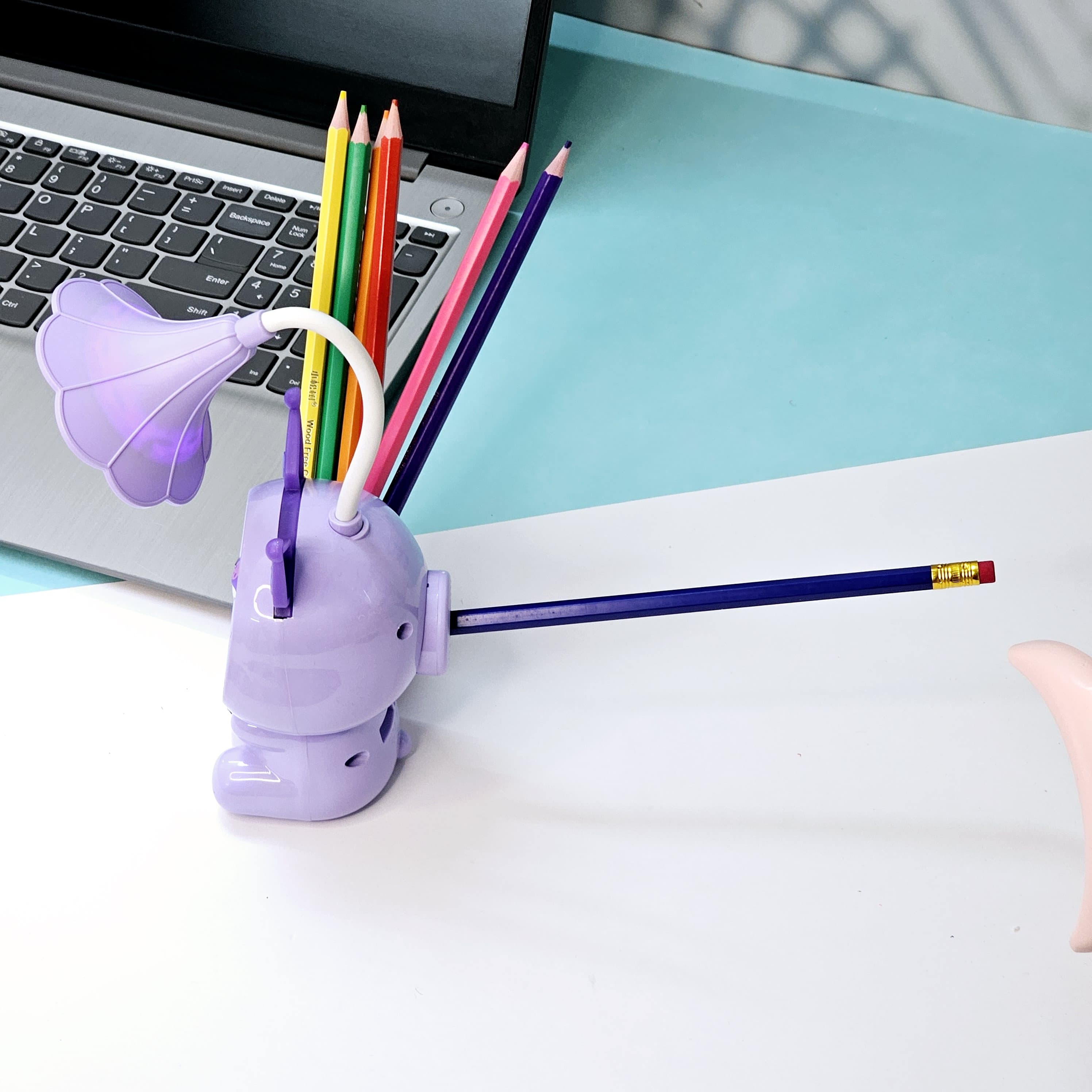 Set of three Usmile Toys Astronaut Teddy Lamps in blue, pink, and green, each featuring a glowing flower-shaped light and a base designed as a convenient pencil holder." www.usmile.toys