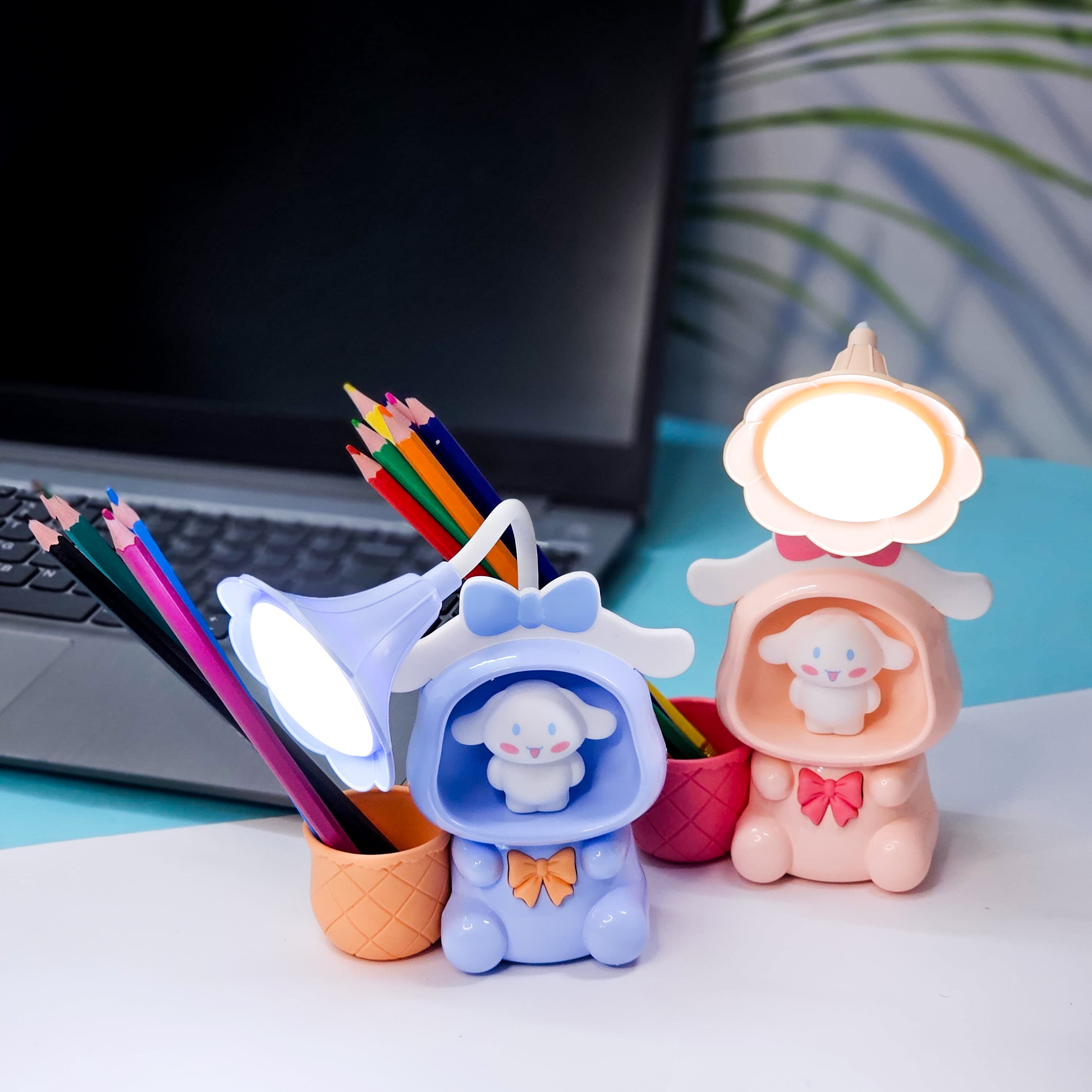 Set of three Usmile Toys Astronaut Teddy Lamps in blue, pink, and green, each featuring a glowing flower-shaped light and a base designed as a convenient pencil holder." www.usmile.toys