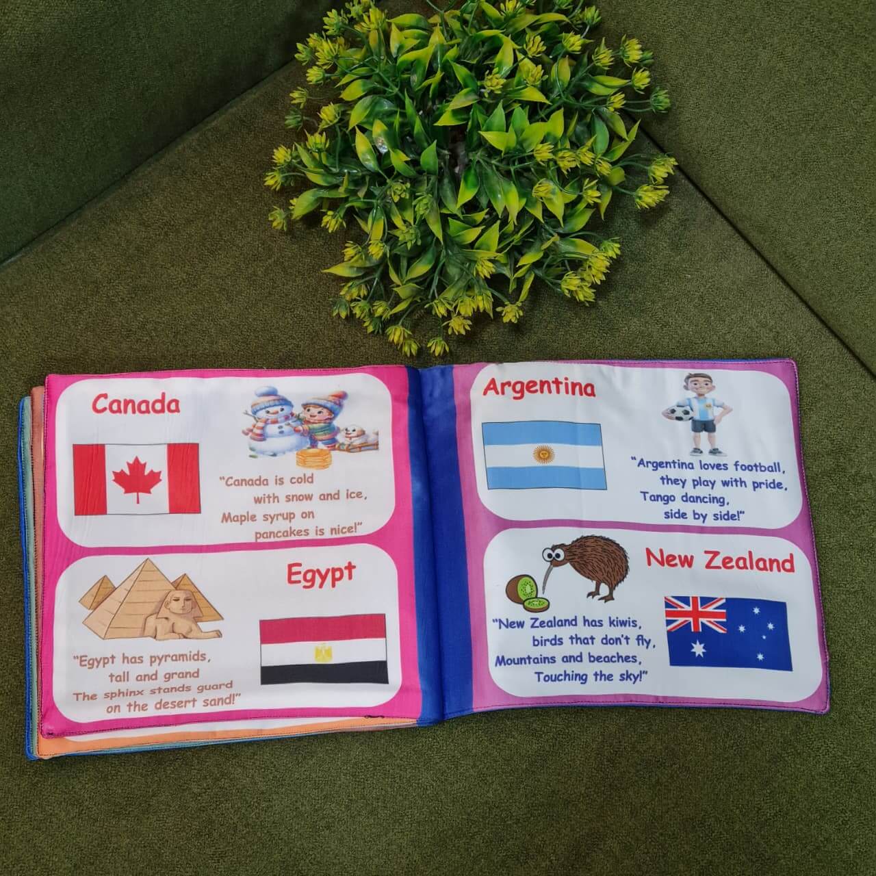"Flag of the World" fabric book by Kidogen, displaying pages about India, USA, Italy, and the United Kingdom with their flags, landmarks, and descriptive rhymes.