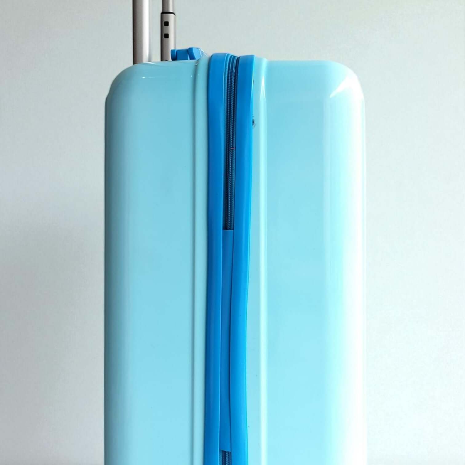Light blue suitcase with a silver handle on a white background