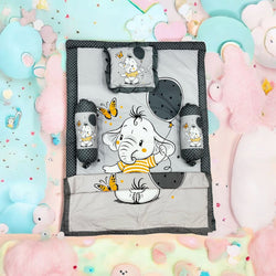 Green 7 in 1 newborn baby bedding set with elephant print, including sleeping bag, mattress, bolsters, pillow, and blankets. www.usmile.com