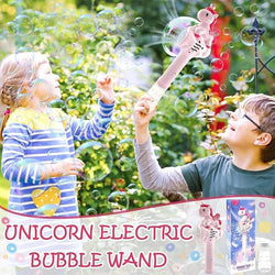 Children playing with a unicorn electric bubble wand in a garden setting.