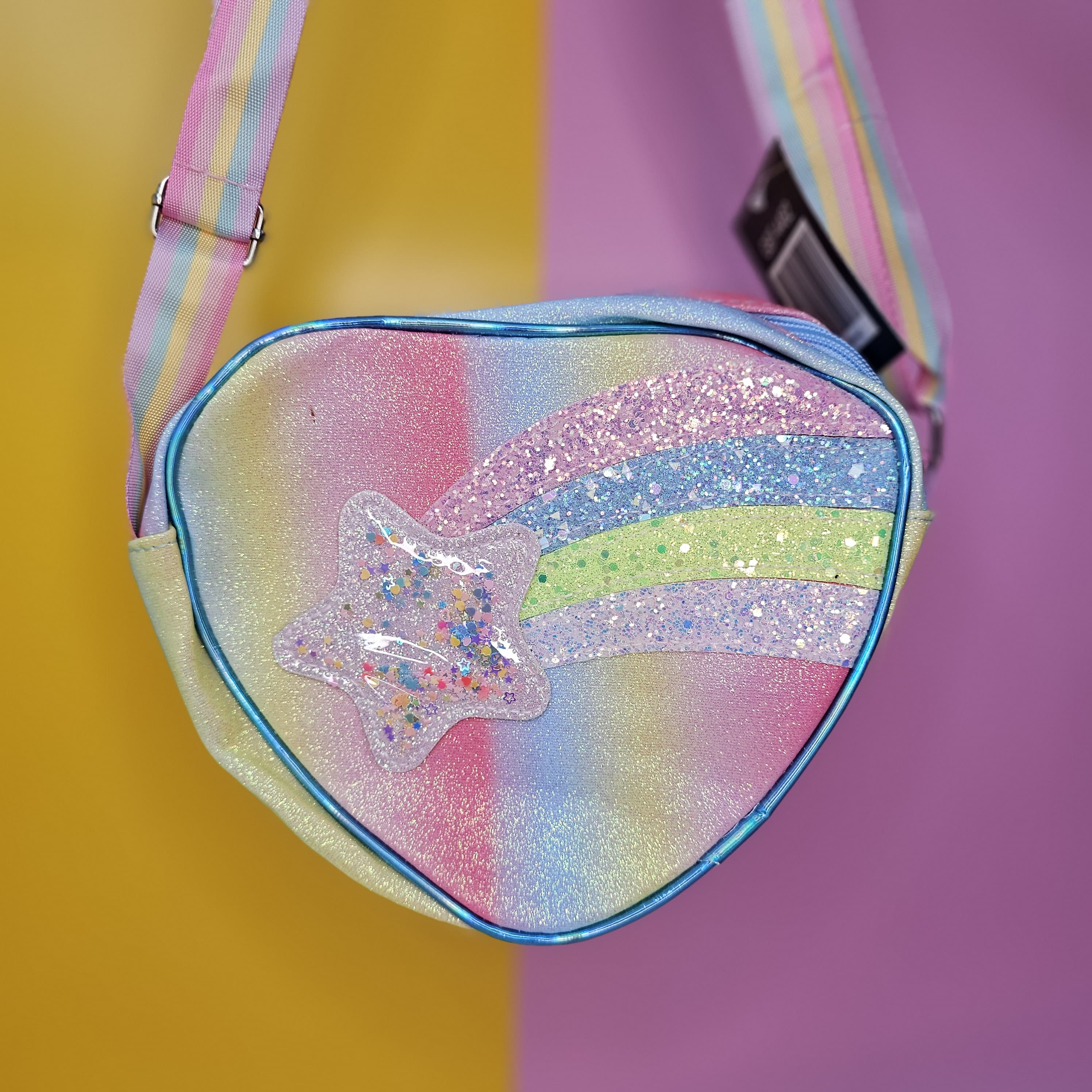 This dazzling rainbow glitter heart mini bag with a comfortable shoulder strap is a fun accessory for fashion-forward girls in www.usmile.toys

